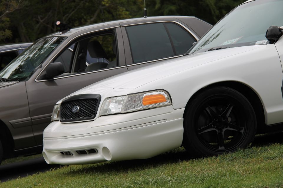 White 2004 Ford Crown Victoria front quarter view with black grille and wheels