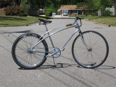 1994 Ford Bronco - A custom cruiser bicycle with a chrome frame and vintage-style seat sits on a paved road in a residential neighborhood.