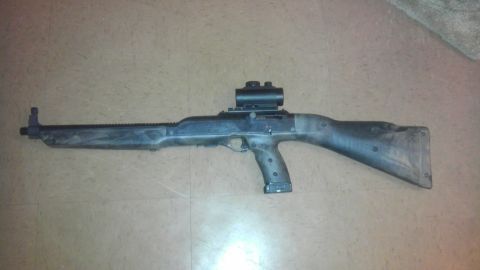 2000 Mercury Grand Marquis - A Hi-Point 995 Carbine rifle with a red dot sight is displayed on a floor.