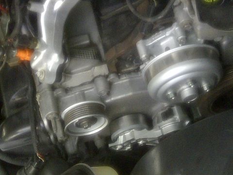 2000 Ford Crown Victoria - Close-up view of an engine's water pump and associated pulleys.