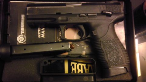 2000 Mercury Grand Marquis - A black Taurus pistol is shown with its instruction manual and magazine.