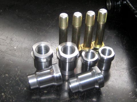 1996 Ford Bronco - Collection of machined metal parts, likely for a vehicle's steering system, including threaded sleeves and bolts.