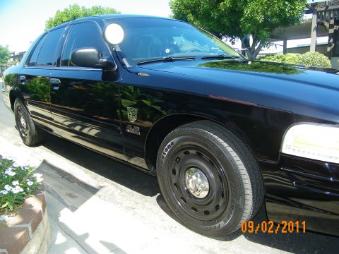 2003 Ford Crown Victoria - Black 2003 Ford Crown Victoria with a police light mounted on the fender.