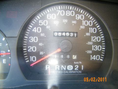 2003 Ford Crown Victoria - Instrument cluster close-up showing 064631 odometer and PRND21 gear selector, certified calibration.