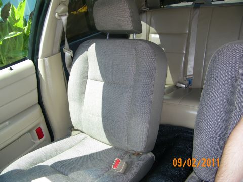 2003 Ford Crown Victoria - Driver bucket seat upholstered in gray fabric, rear seating and door panel behind it