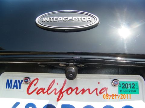 2003 Ford Crown Victoria - Rear camera below the Interceptor trunk emblem of a dark Crown Victoria; California plate with MAY 2012 tag.
