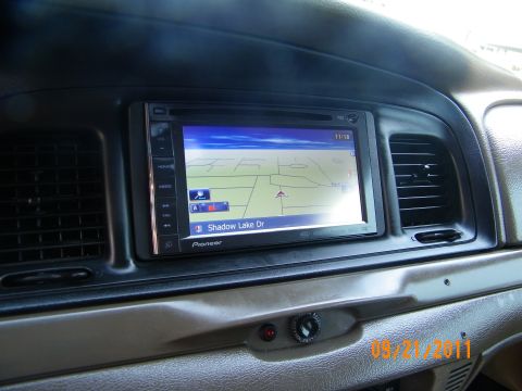 2003 Ford Crown Victoria - In-dash Pioneer GPS display with route map labeled Shadow Lake Dr, flanked by dashboard vents