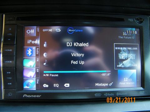 2003 Ford Crown Victoria - Close-up of Pioneer media player interface showing source icons, album art and paused track