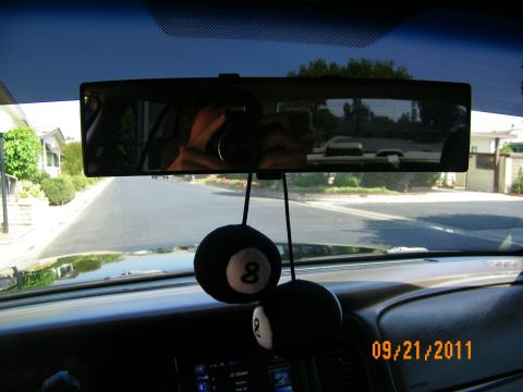 2003 Ford Crown Victoria - Driver perspective showing road ahead, mirror reflecting photographer and eight-ball dice hanging