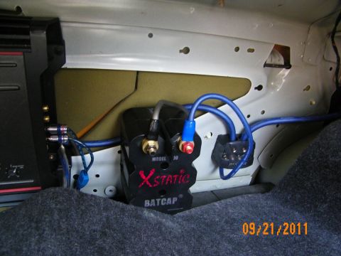 2003 Ford Crown Victoria - Xstatic BatCap unit mounted to trunk sheet metal with blue power and ground cabling.