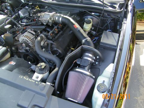 2003 Ford Crown Victoria - K&N cone filter on an aftermarket intake routed past the alternator in the engine bay.