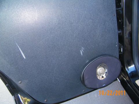 2003 Ford Crown Victoria - Inner door panel fitted with a Kicker oval speaker in the lower grille position.
