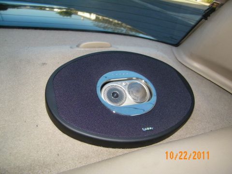 2003 Ford Crown Victoria - Round Infinity speaker with blue cone seated in the tan rear shelf