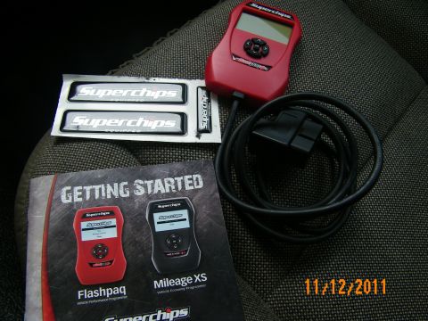 2003 Ford Crown Victoria - Red Superchips Flashpaq programmer beside its cable, stickers and manual, dated 11/12/2011