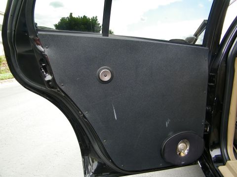 2003 Ford Crown Victoria - Open rear door showing a fabric-wrapped custom panel with midrange and component speakers