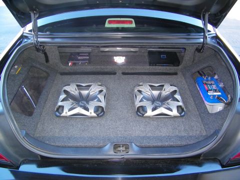 2003 Ford Crown Victoria - Open sedan trunk fitted with twin Kicker subs, an amp rack and a power capacitor