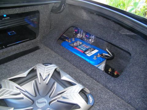 2003 Ford Crown Victoria - Detail of a Kicker sub, blue battery and Alpine amplifier installed in a car trunk