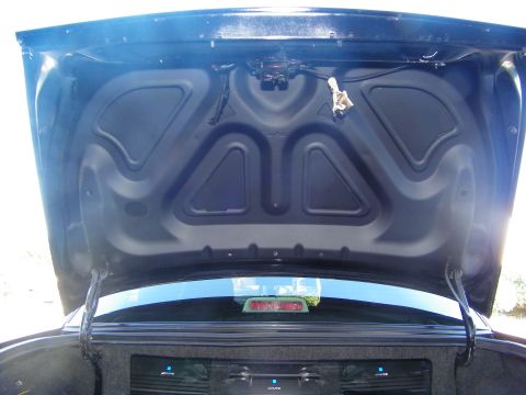 2003 Ford Crown Victoria - View of the inner trunk lid panel with amplifiers glowing on the rear deck below