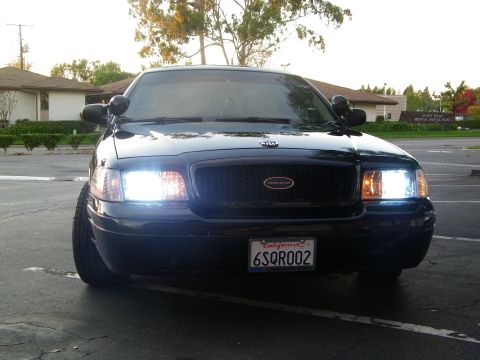 2003 Ford Crown Victoria - Front-on view of a black Crown Victoria Interceptor with HID headlights and dark grille.