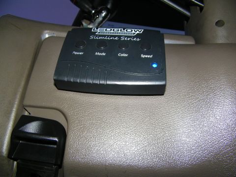 2003 Ford Crown Victoria - LEDGlow Slimline Series LED control unit on a beige interior surface, blue status light glowing.