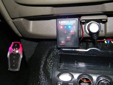 2003 Ford Crown Victoria - Black LEDGlow control module with Sound and Mode buttons wired into a car interior beside a power socket.