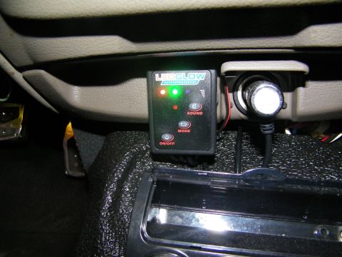 2003 Ford Crown Victoria - LEDGlow LED controller fixed beneath a vehicle dash, status lights lit, chrome accessory alongside.
