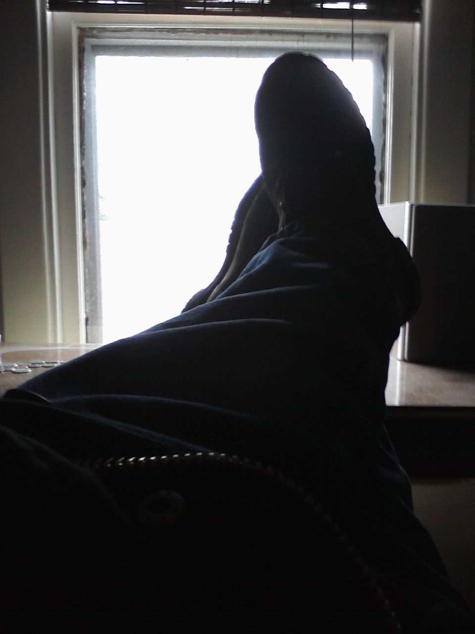 Person's legs and feet in silhouette against a bright window. Supermotors.net logo visible