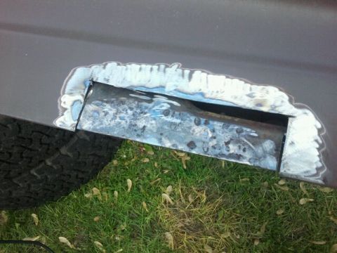 1979 Ford Bronco - A close-up view shows metalwork being performed on a vehicle's body panel.