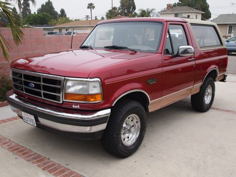1994 Ford Bronco - This 1994 Ford Bronco is shown in a three-quarter front view, parked on a paved driveway.