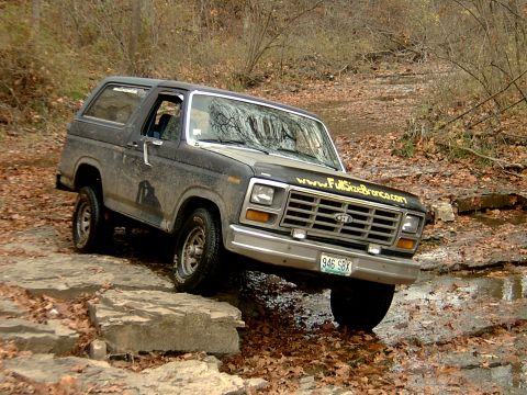 1982 Ford Bronco - This 1982 Ford Bronco navigates a rocky trail, displaying the website www.FullSizeBronco.com on its hood.