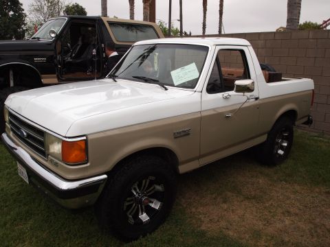 1994 Ford Bronco - This two-tone 1994 Ford Bronco is shown from the front three-quarter view, with another Bronco visible behind it.