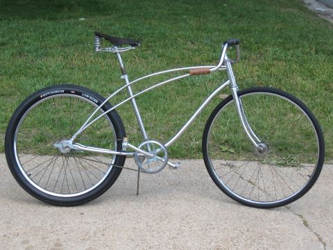 1994 Ford Bronco - A custom lowrider bicycle with chrome frame and black tires sits on a concrete path.