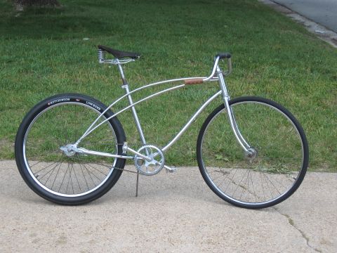 1994 Ford Bronco - A custom lowrider bicycle with a chrome frame and wide tires is parked on a sidewalk.