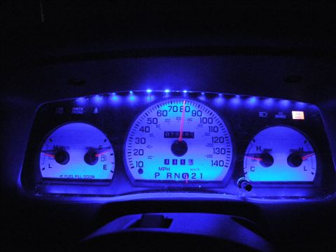 2003 Ford Crown Victoria - Dashboard instrument panel lit blue with side fuel, volts, temp and oil gauges