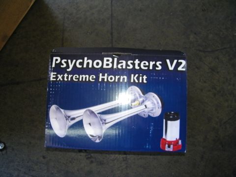 2003 Ford Crown Victoria - Boxed dual air horn kit labeled PsychoBlasters V2 Extreme Horn Kit sitting on shop floor