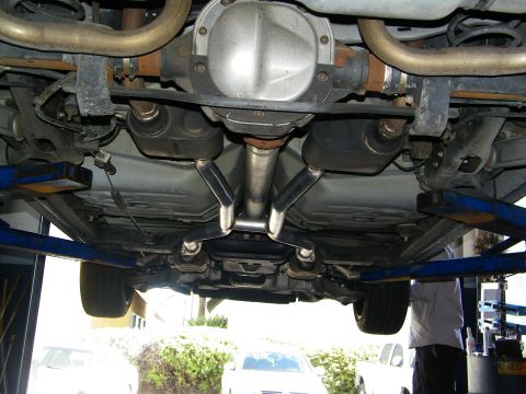 2003 Ford Crown Victoria - Underbody view of a rear differential and dual exhaust system with mufflers on a two-post lift