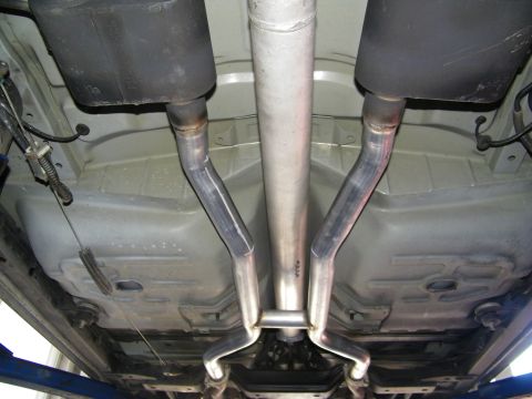 2003 Ford Crown Victoria - Twin mufflers and tailpipes following the floor pan beneath a vehicle on a lift
