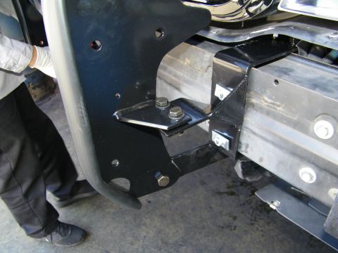 2003 Ford Crown Victoria - Black grille guard bracket bolted to the frame rail of a truck during installation