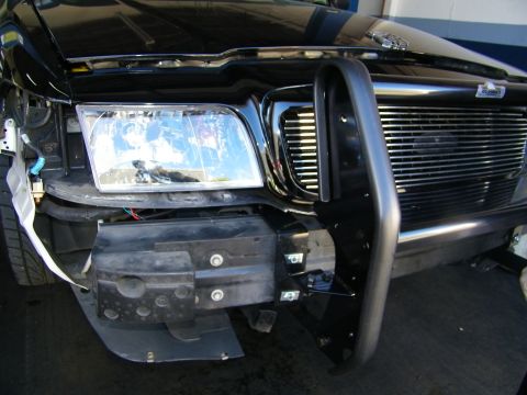 2003 Ford Crown Victoria - Black tubular grille guard fitted next to the headlight and billet grille on a truck