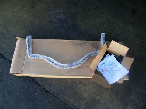 2003 Ford Crown Victoria - Long carton on concrete containing a foam-padded component and an instruction document with red text