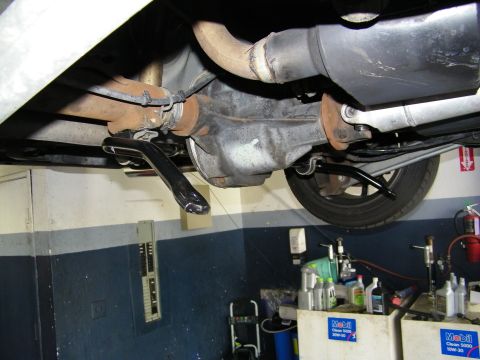 2003 Ford Crown Victoria - Undercarriage showing differential housing, driveshaft and exhaust with Mobil oil bottles below