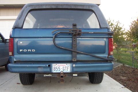 1980 Ford Bronco - Rear view of a blue Ford Bronco, equipped with a spare tire carrier and a Washington state license plate.