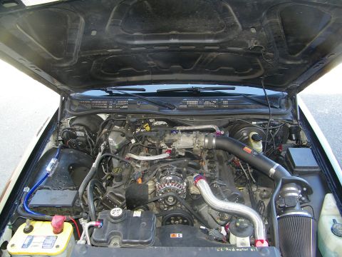 2003 Ford Crown Victoria - Engine compartment detail of a 4.6 V8 with cold-air intake and aftermarket components.