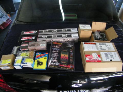 2003 Ford Crown Victoria - Performance build parts laid out on a Ford trunk with shipping cartons and tuner.