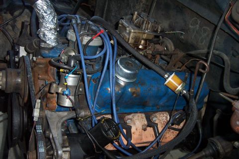 1980 Ford Bronco - Close-up view of a vehicle's engine compartment, showing various components and wiring.