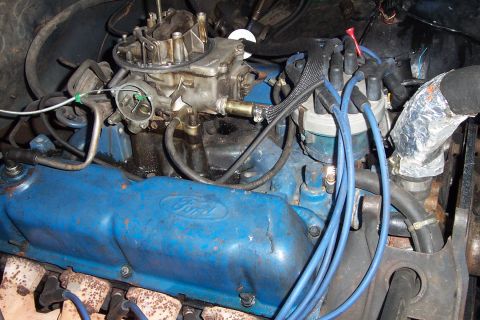 1980 Ford Bronco - Close-up view of a Ford V8 engine, showing the carburetor and blue spark plug wires.