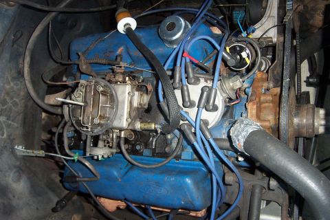 1980 Ford Bronco - The engine bay shows a blue Ford V8 engine with visible carburetor and spark plug wires.
