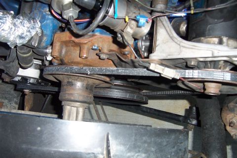 1980 Ford Bronco - Close-up view of engine pulleys, belts, and associated mechanical parts.