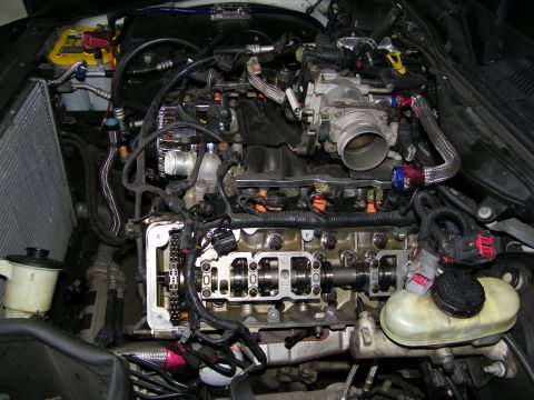 2003 Ford Crown Victoria - Engine compartment with one cylinder head off, exposing valves and intake plumbing