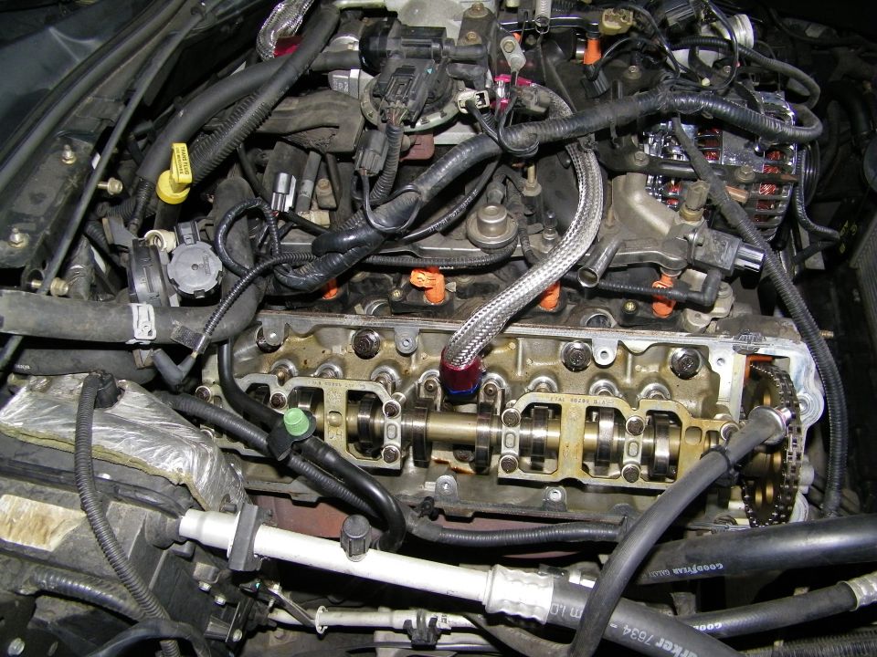 Exposed engine cylinder head and valvetrain with timing chain during teardown